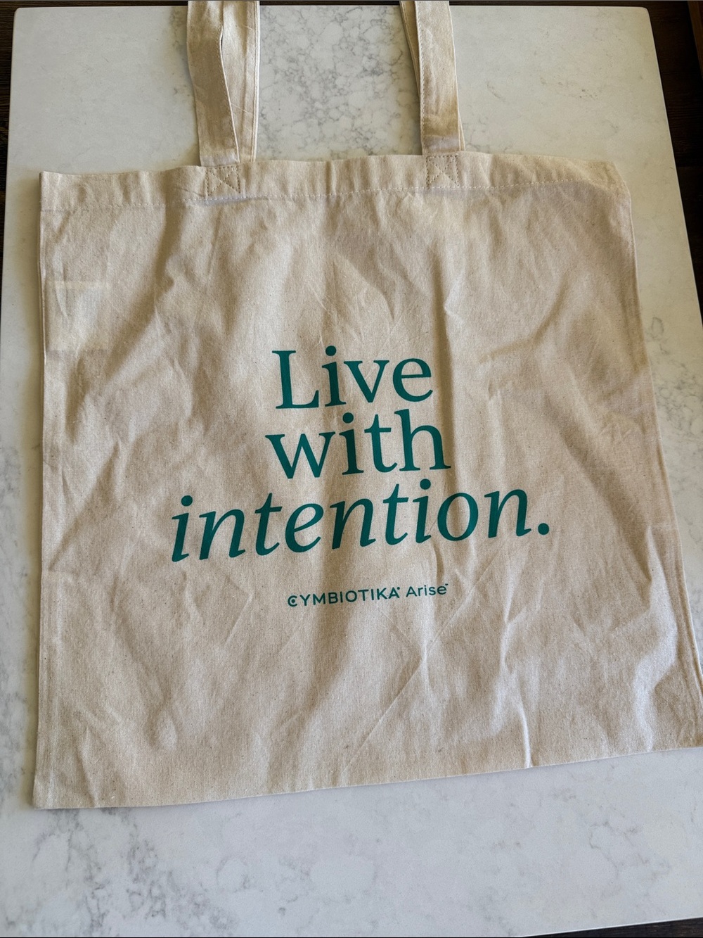Live with intention. Canvas Tote Bag by SYMBIOTIKA Arise